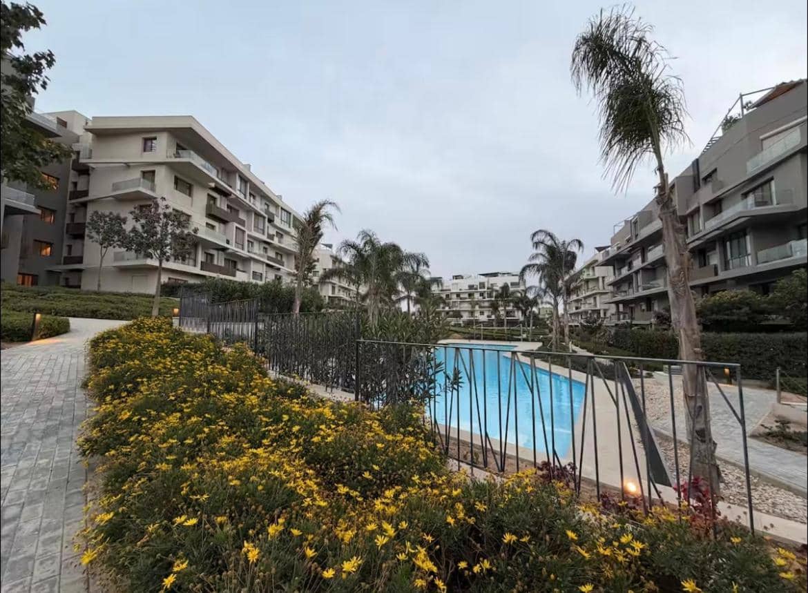 A Luxurious Bedroom And a Cozy Living Area with a Stunning View of the Swimming Pool — 4
